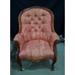 A Victorian carved walnut framed armchair, floral decorated frame, cabriole legs and castors. 93 x 7