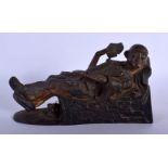 A RARE VICTORIAN AMERICAN CAST IRON RECLINING CHINAMAN MONEY BOX modelled holding cards. 22 cm x 12