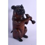 AN ANTIQUE BLACK FOREST BAVARIAN TOBACCO JAR modelled as a dog smoking a pipe. 21 cm high.