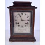 A wooden mantel clock with a silvered dial. 34cm high