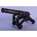 A MID 19TH CENTURY CONTINENTAL CAST IRON DESK CANNON on a rolling frame. 30 cm x 18 cm.