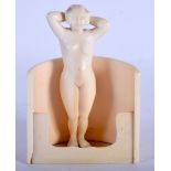 AN ART DECO CARVED IVORY FIGURE OF A BATHING WOMEN modelled nude. 9 cm x 7 cm.