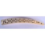 AN ANTIQUE WALRUS TUSK SCRIMSHAW CRIBBAGE BOARD. 42 cm long.