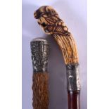 A 19TH CENTURY JAPANESE MEIJI PERIOD CARVED STAG ANTLER WALKING CANE together with a Chinese silver