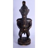 AN AFRICAN TRIBAL CARVED WOOD FIGURE modelled as a male with a long beard. 24 cm high.