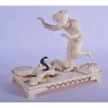 A FINE 19TH CENTURY ANGLO INDIAN CARVED IVORY FIGURE OF A SNAKE CHARMER modelled alarmed by a rearin