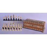 A FINE 19TH CENTURY ANGLO INDIAN CARVED IVORY SAHIB CHESS SET within a sandalwood ivory overlaid fil