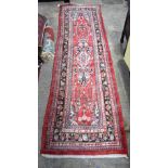 A Persian red ground rug 367 x 109