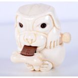 A small Ivory tape measure in the form of a dog. 5.5 cm .