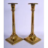 A PAIR OF GEORGE III BRASS CANDLESTICKS. 27 cm high.