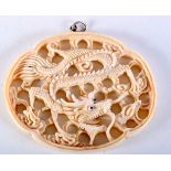 A CHINESE CARVED BONE DRAGON PENDANT. 7.6cm x 6.2cm, weight 26g