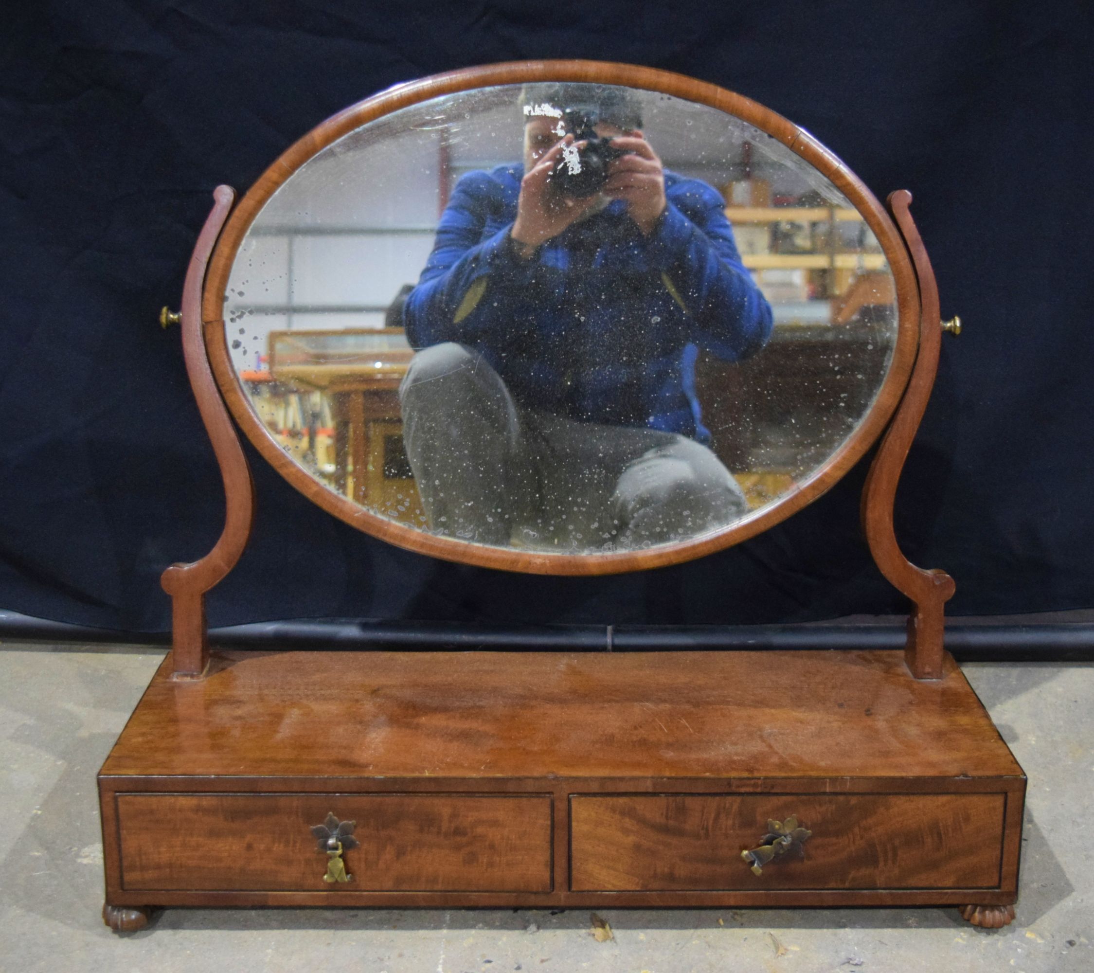 A large19th century mahogany dressing mirror, oval swing plate, 2 drawers to base , rosewood carved