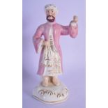 A 19TH CENTUEY FRENCH PARIS PORCELAIN FIGURE OF A TURK modelled upon a gilt base. 18 cm high.