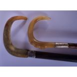 A 19TH CENTURY MIDDLE EASTERN SILVER MOUNTED RHINOCEROS HORN CANE and a similar parasol. Largest 88