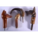 TWO 19TH CENTURY CONTINENTAL CARVED RHINOCEROS HORN STICKS together with a pair of wooden handles. (