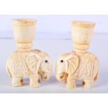 A PAIR OF CARVED BONE CANDLESTICKS IN THE FORM OF ELEPHANTS. 9.2cm x 6.3cm, total weight 257g