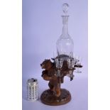A 19TH CENTURY BAVARIAN BLACK FOREST CARVED WOOD LIQUOR SET with glasses and decanter. Bear 27 cm x