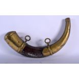 A 19TH CENTURY MIDDLE EASTERN BRASS OVERLAID HORN POWDER FLASK. 33 cm long.
