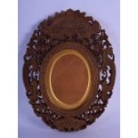 A 19TH CENTURY INDIAN MIDDLE EASTERN CARVED SANDALWOOD FRAME decorated with flowers and vines. 30 cm
