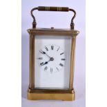 AN ANTIQUE FRENCH REPEATING BRASS CARRIAGE CLOCK. 15 cm high inc handle.