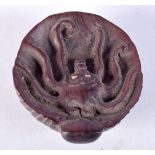 A CHINESE ROUND NETSUKE CARVED WITH AN OCTOPUS. 4cm diameter