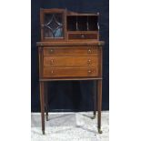 A small Edwardian veneered four drawer writing cabinet with a glass fronted cupboard 105 x 51 x 37