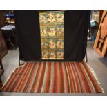 A MIDDLE EASTERN MULTI TONE GROUND RUG together with an Indian scroll. Largest 185 cm x 115 cm. (2)