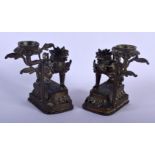 A PAIR OF 19TH CENTURY SOUTH EAST ASIAN BRONZE CANDLESTICKS formed as beasts. 10 cm x 6 cm.