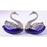 A PAIR OF WHITE METAL MOUNTED BLUE GLASS SWAN SALTS. Each 8.4cm x 7.4cm, total weight 169g