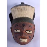 AN AFRICAN TRIBAL PAINTED WOOD YORUBA TYPE HELMET MASK. 30 cm x 25 cm.