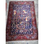 A Persian red and blue ground rug possibly Tabriz 180 x 112 cm