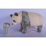 A CONTEMPORARY PAINTED POTTERY MODEL OF A PANDA modelled roaming. 35 cm x 25 cm.
