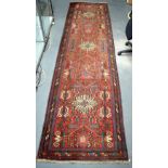 A MIDDLE EASTERN PERSIAN RUNNER decorated with motifs. 390 cm x 100 cm.