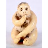 A 19TH CENTURY JAPANESE MEIJI PERIOD CARVED STAG ANTLER NETSUKE formed as a seated monkey. 4 cm x 2