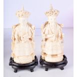 A PAIR OF EARLY 20TH CENTURY CHINESE CANTON IVORY FIGURES modelled upon thrones. 19 cm high.