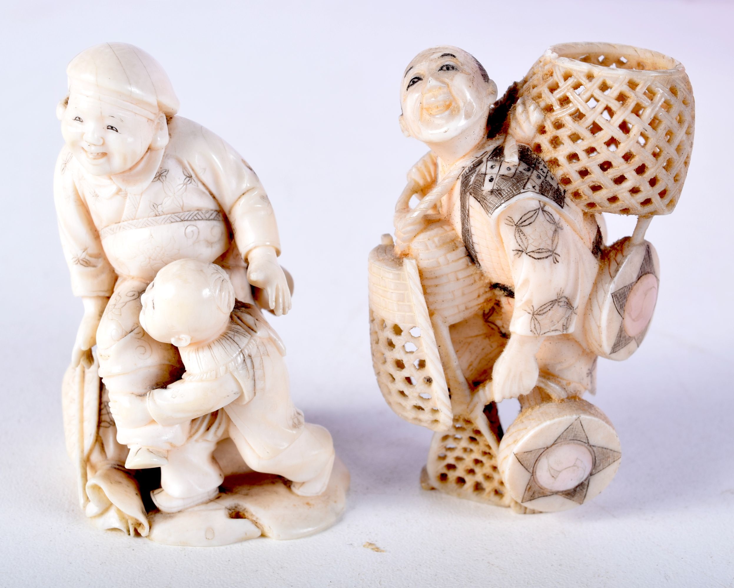 TWO 19TH CENTURY JAPANESE MEIJI PERIOD CARVED IVORY OKIMONO one modelled as a basket seller. Largest