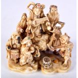 A FINE 19TH CENTURY JAPANESE MEIJI PERIOD CARVED IVORY OKIMONO modelled with numerous figures in var