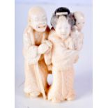 A 19TH CENTURY JAPANESE MEIJI PERIOD CARVED IVORY OKIMONO modelled as a scholar and female. 8 cm x 4