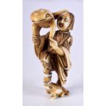 A 19TH CENTURY JAPANESE MEIJI PERIOD CARVED IVORY NETSUKE in the form of scholar holding a toad. 7.2
