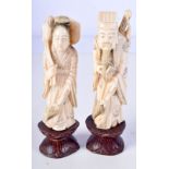 A PAIR OF 19TH CENTURY CHINESE CARVED IVORY FIGURES OF IMMORTALS modelled holding floral sprigs. 11