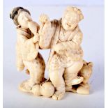 A 19TH CENTURY JAPANESE MEIJI PERIOD CARVED IVORY OKIMONO modelled as figures with dogs. 7 cm x 5 cm