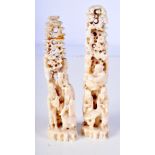 A PAIR OF 19TH CENTURY CHINESE CARVED IVORY MOUNTAIN GROUPS formed with scholars. 14 cm high.