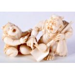 A 19TH CENTURY JAPANESE MEIJI PERIOD CARVED IVORY OKIMONO modelled as two devilish figures. 8 cm x 4