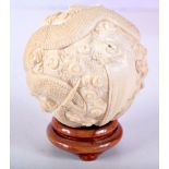 A FINE 19TH CENTURY JAPANESE MEIJI PERIOD CARVED IVORY DRAGON BALL modelled amongst clouds. 5.25 cm