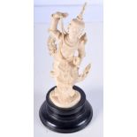 A 19TH CENTURY ANGLO INDIAN CARVED IVORY FIGURE OF A DEITY modelled with one hand raised. 21 cm high