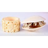A 19TH CENTURY JAPANESE MEIJI PERIOD CARVED IVORY CLAM SHELL together with a Canton napkin ring. Lar