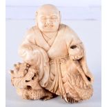 AN 18TH/19TH CENTURY CHINESE CARVED IVORY FIGURE OF A BUDDHA modelled upon a dragon holding a censer