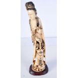 A 19TH CENTURY CHINESE CARVED IVORY FIGURE OF AN IMMORTAL modelled holding a basket. 28 cm high.