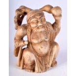 A 19TH CENTURY CHINESE CARVED IVORY FIGURE OF A BUDDHA modelled holding aloft a fruit. 7 cm x 4.5 cm