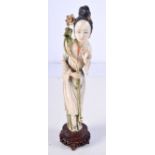 A LARGE 19TH CENTURY CHINESE CARVED POLYCHROMED IVORY FIGURE OF A FEMALE modelled holding flower. 29